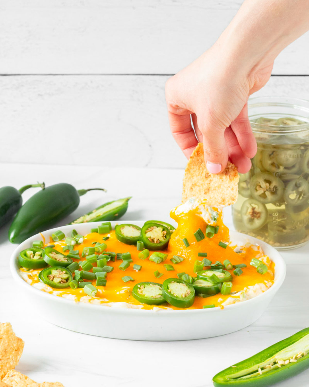 This jalapeno popper dip is a great game day appetizer and one of our favorite Super Bowl Sunday appetizer recipes. Made with classic jalapeno popper ingredients, this easy dip recipe is ready in 15-minutes for a quick and easy crowd-pleaser appetizer.