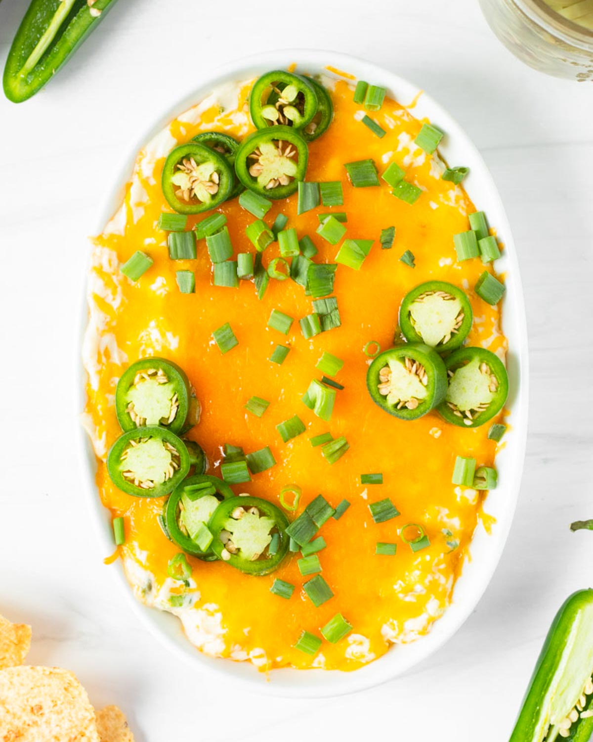 This jalapeno popper dip is a great game day appetizer and one of our favorite Super Bowl Sunday appetizer recipes. Made with classic jalapeno popper ingredients, this easy dip recipe is ready in 15-minutes for a quick and easy crowd-pleaser appetizer.