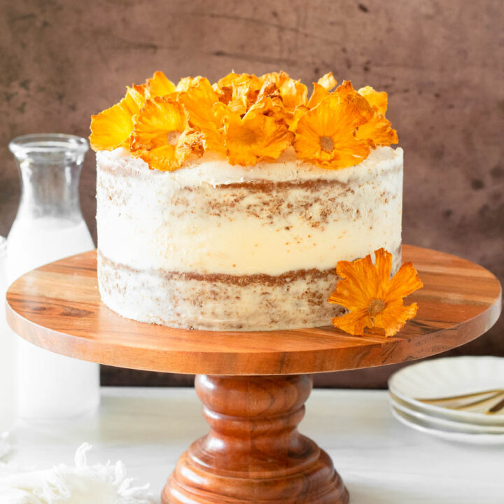 This hummingbird cake is delicious tropical banana-pineapple cake filled with crushed pineapple, overripe bananas, walnuts, and cinnamon topped with a buttercream frosting.