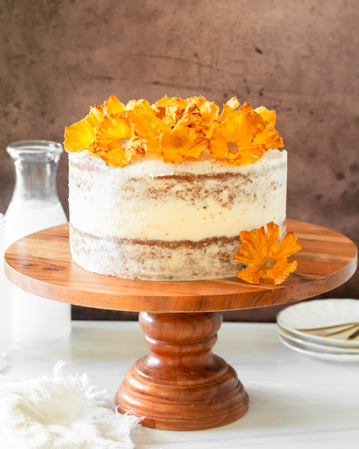 This hummingbird cake is delicious tropical banana-pineapple cake filled with crushed pineapple, overripe bananas, walnuts, and cinnamon topped with a buttercream frosting.