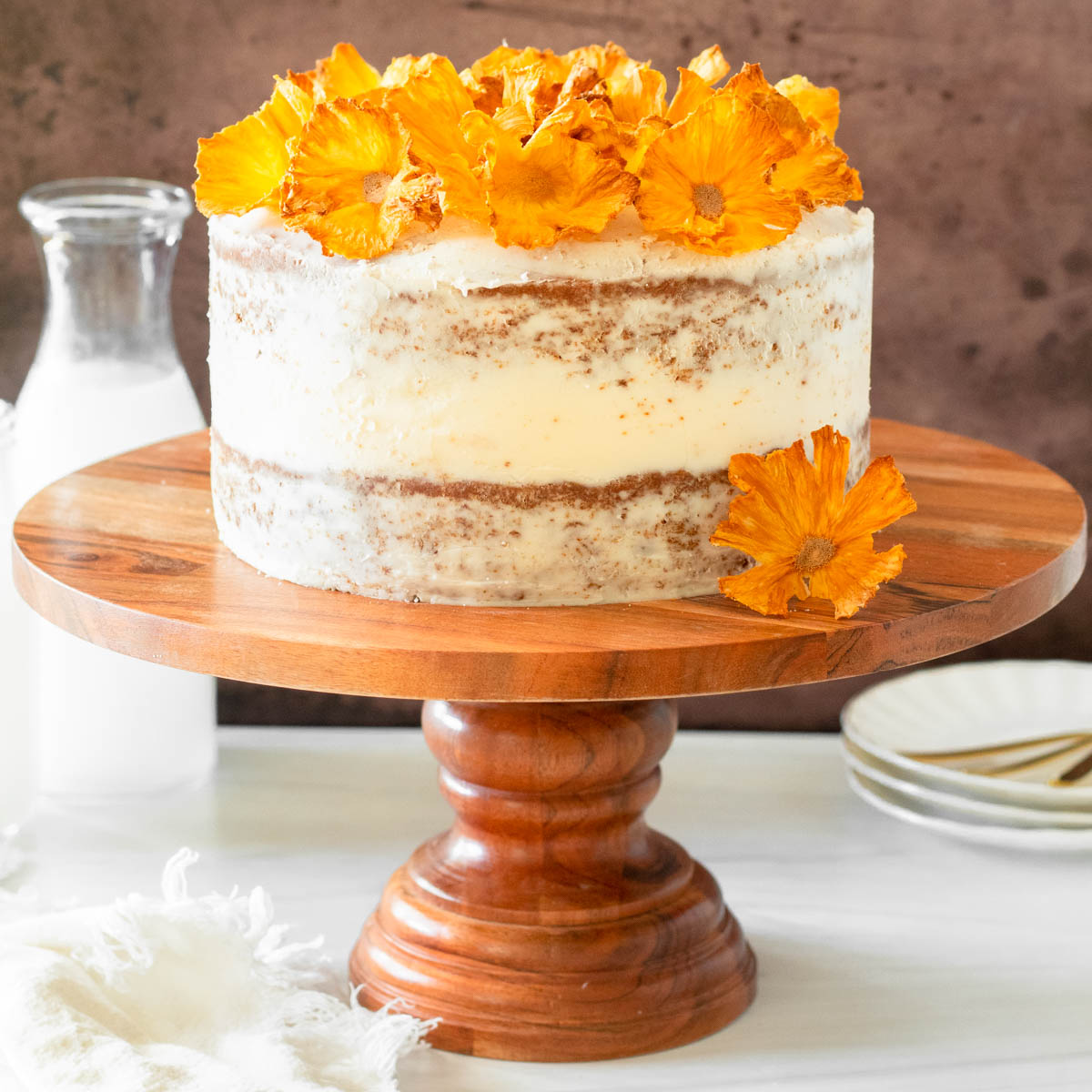 This hummingbird cake is delicious tropical banana-pineapple cake filled with crushed pineapple, overripe bananas, walnuts, and cinnamon topped with a buttercream frosting.