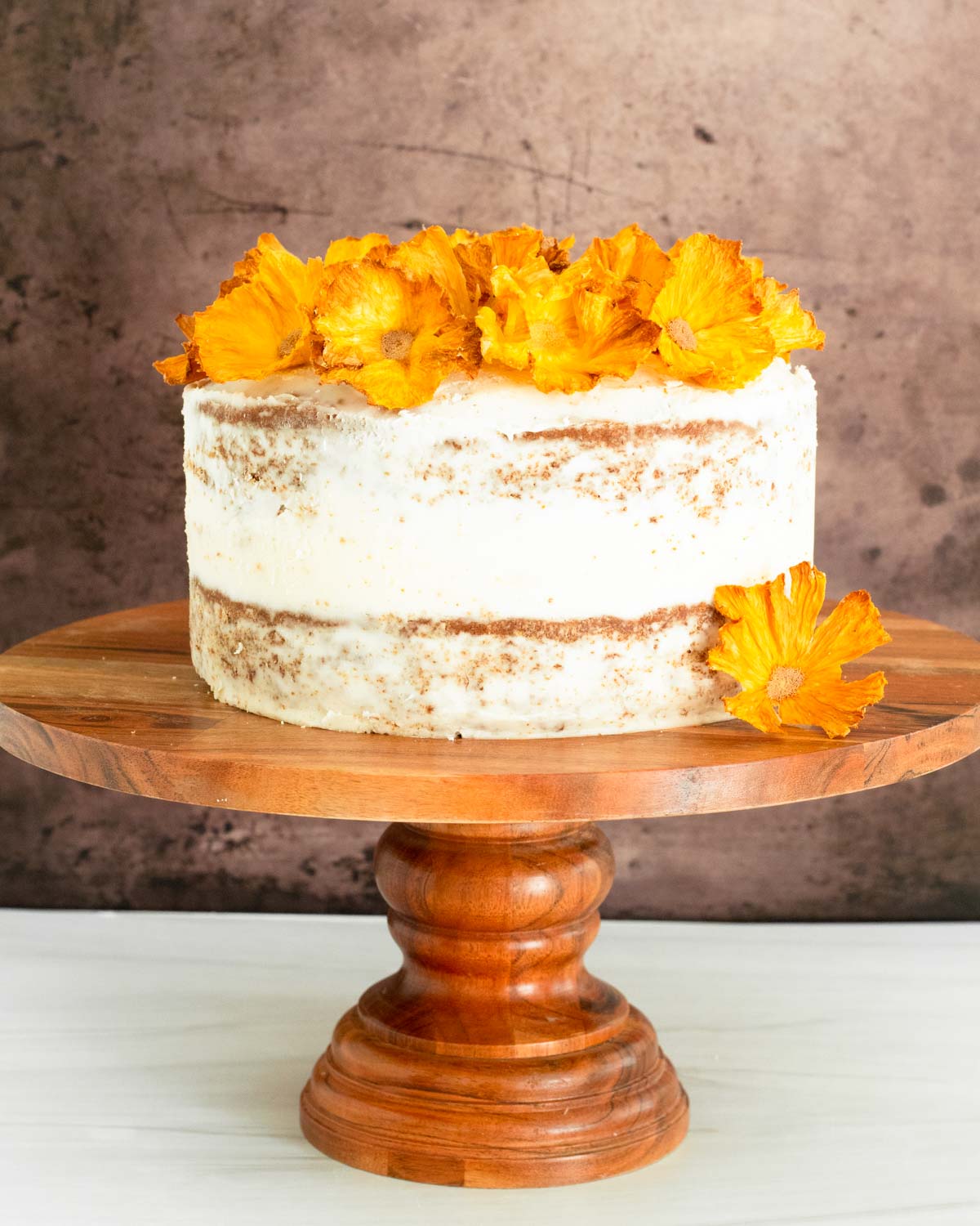 This hummingbird cake is delicious tropical banana-pineapple cake filled with crushed pineapple, overripe bananas, walnuts, and cinnamon topped with a buttercream frosting.