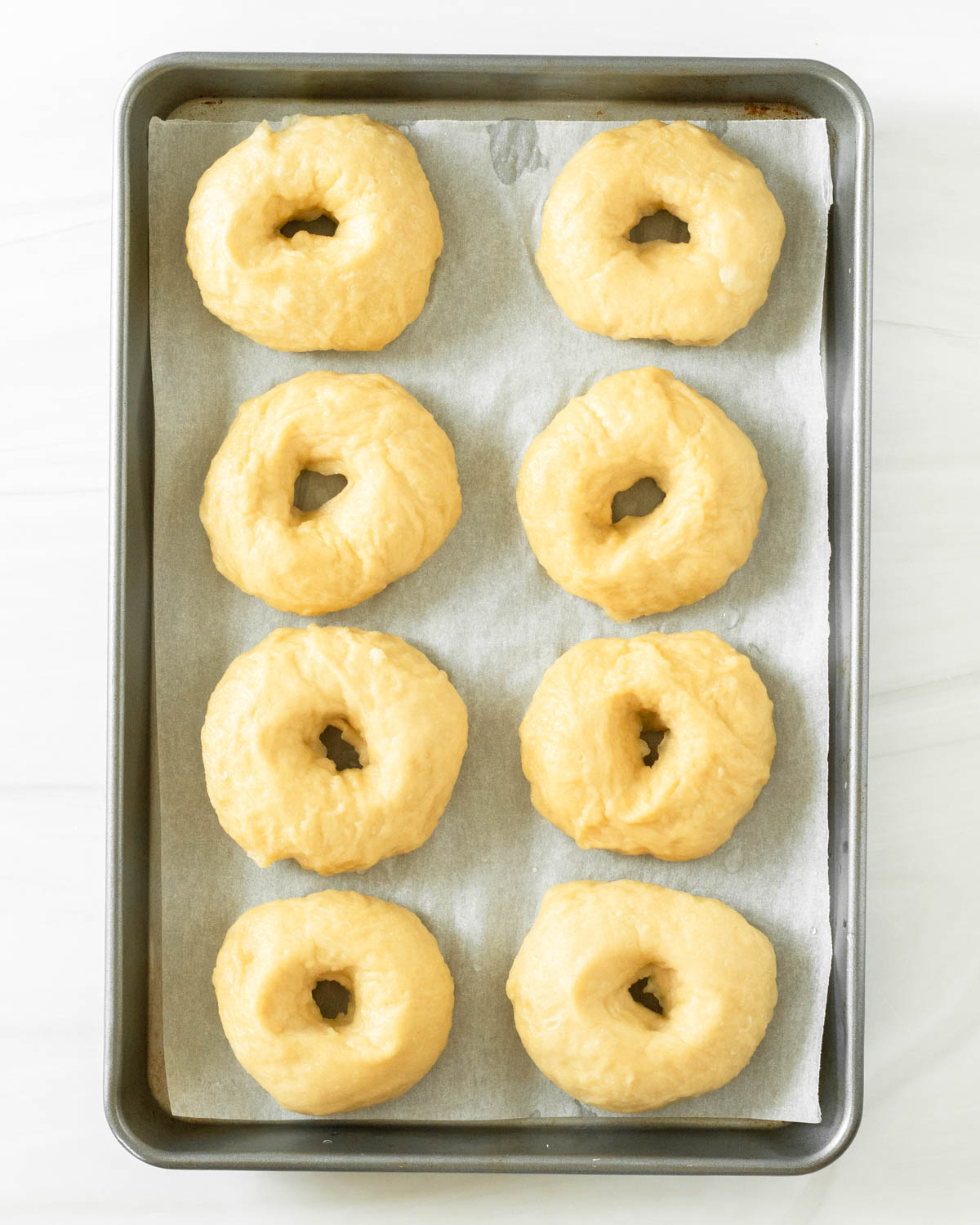 Step 8. Place the boiled bagels on a sheet pan