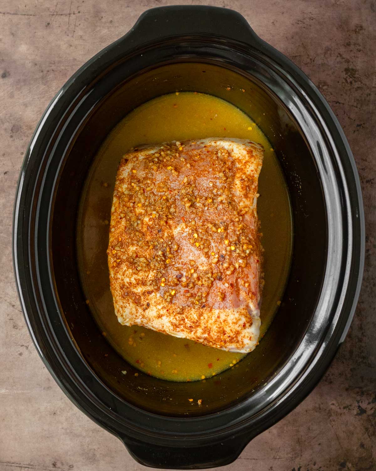 Step 1. Add the pork, orange and lime juice to the crockpot and allow to cook