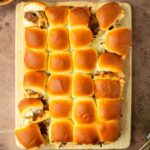 These BBQ pulled beef sliders are an easy and delicious Hawaiian roll pull-apart sandwich made with BBQ pulled beef and mozzarella cheese layered inside perfectly baked Hawaiian rolls for an easy dinner, delicious appetizer and the perfect recipe to serve a crowd.