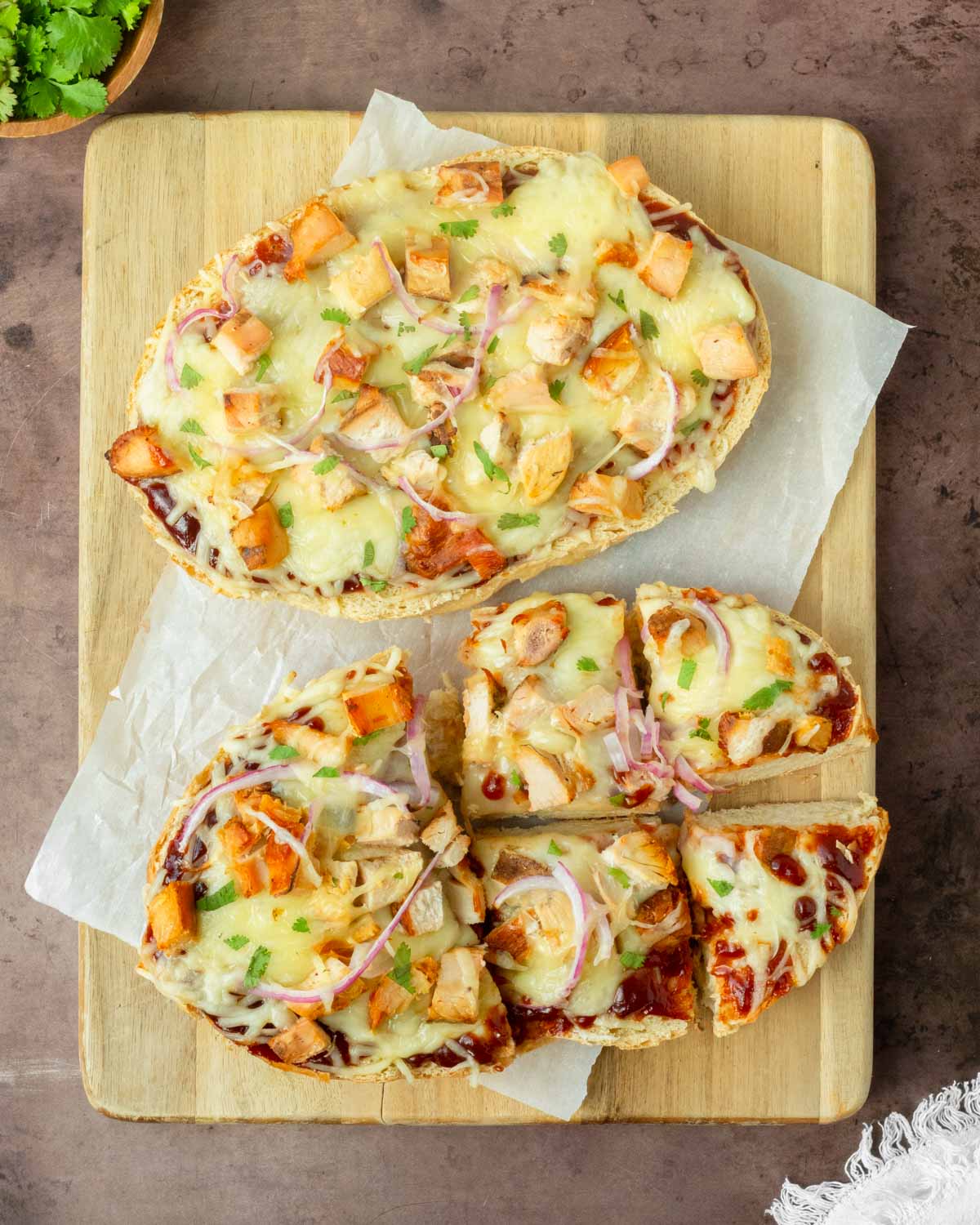 This BBQ chicken French bread pizza is an easy homemade pizza recipe made with homemade French bread topped with classic pizza toppings for a quick and delicious dinner recipe.