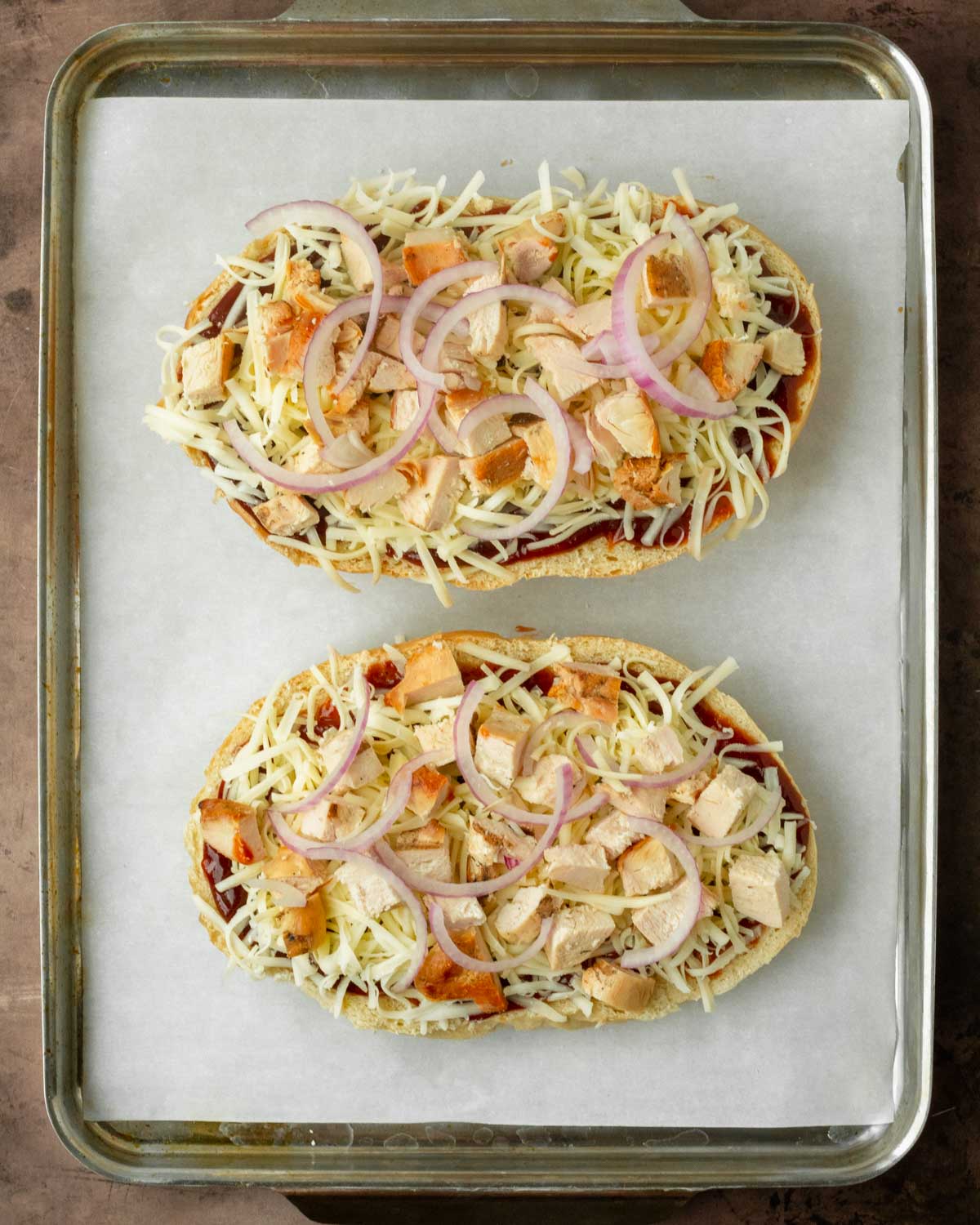 Step 1. Cut the bread in half and top with the pizza toppings