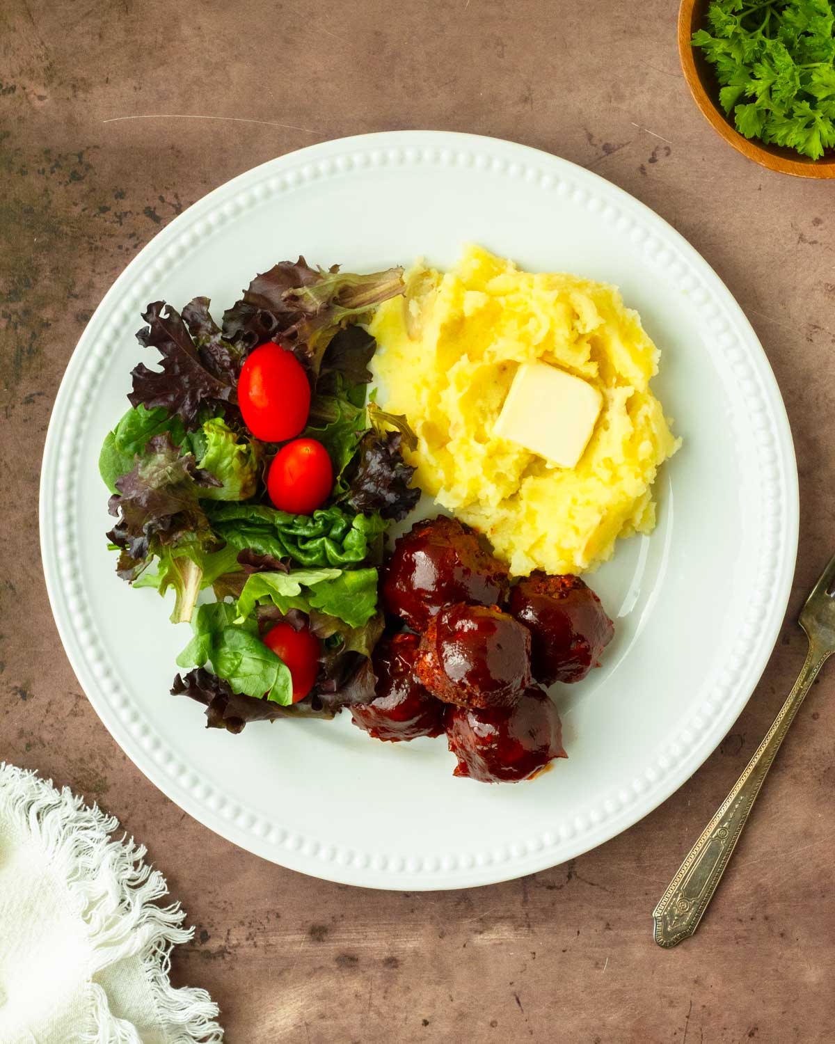 These BBQ meatloaf meatballs are a quick and easy dinner recipe made with classic meatloaf ingredients for flavorful, juicy meatballs topped with a barbeque sauce glaze.