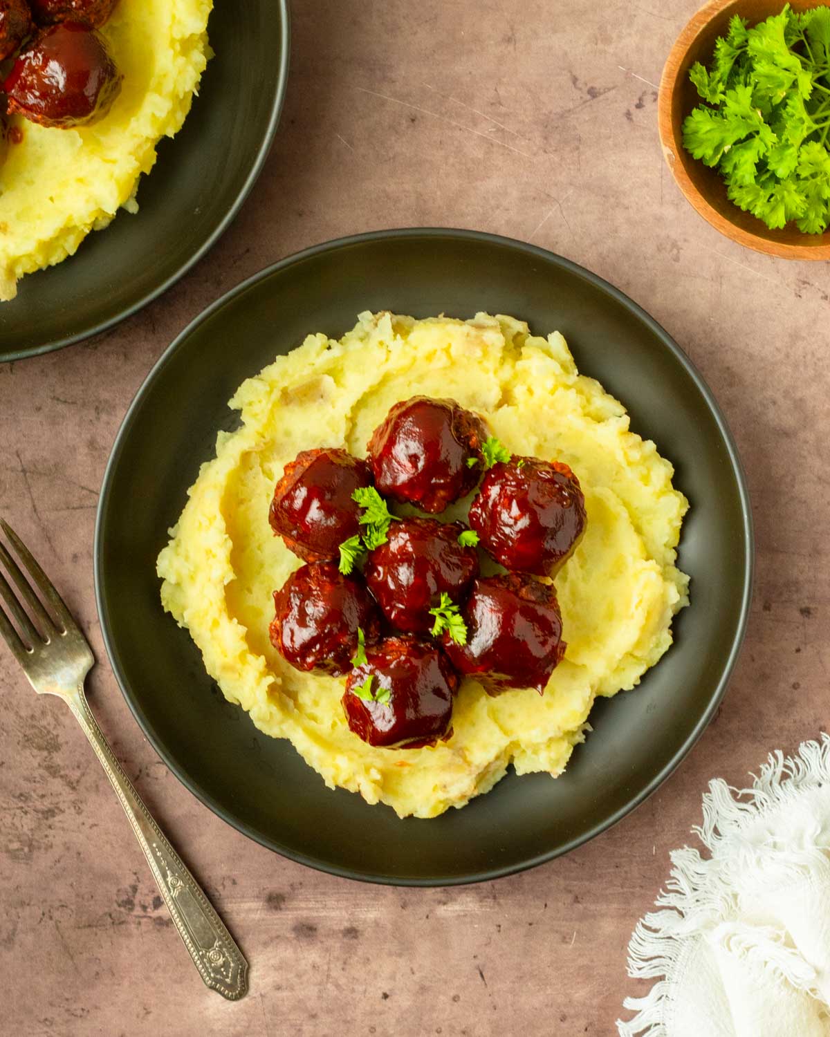These BBQ meatloaf meatballs are a quick and easy dinner recipe made with classic meatloaf ingredients for flavorful, juicy meatballs topped with a barbeque sauce glaze.