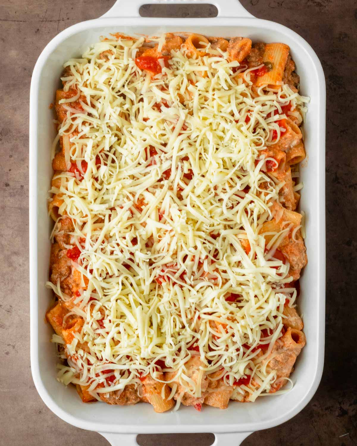 Step 2. Transfer the pasta to a baking dish and top with cheese