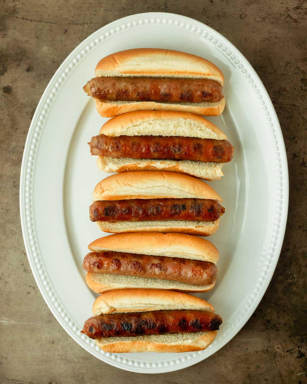 Step 1. Grill the brats and place them in the buns