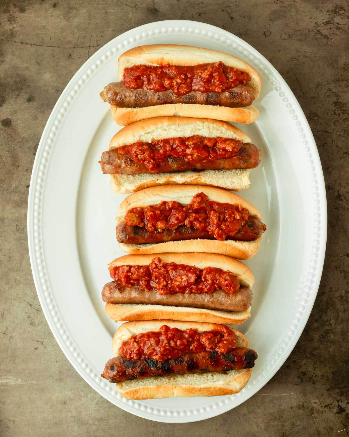 Step 2. Add the chili on top of the brats