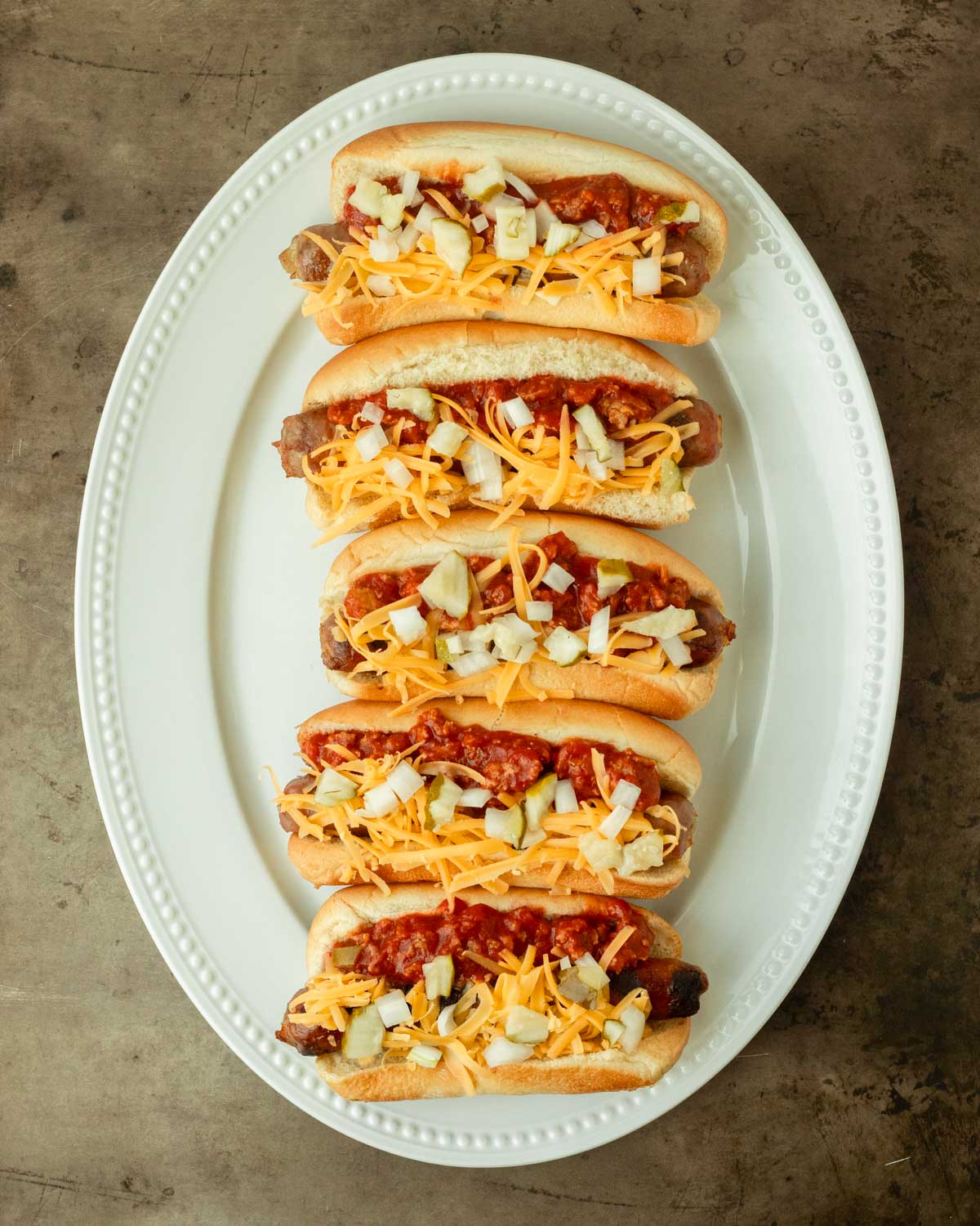 Step 3. Top with the cheese, onion and pickles