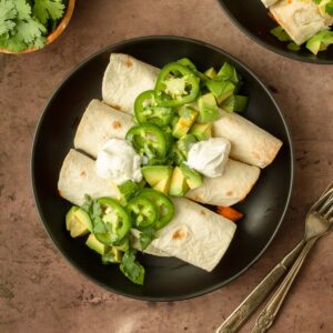 These green chile chicken taquitos are an easy dinner made with tortillas stuffed with a flavorful green chile chicken filling and cheese perfect for a quick weeknight dinner.