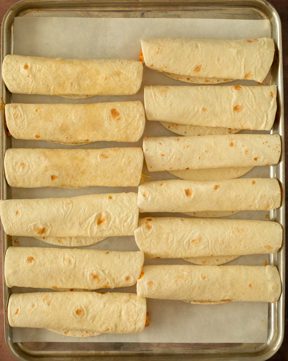 Step 2. Fill the tortillas with the chicken mixture and cheese, and roll up the taquitos