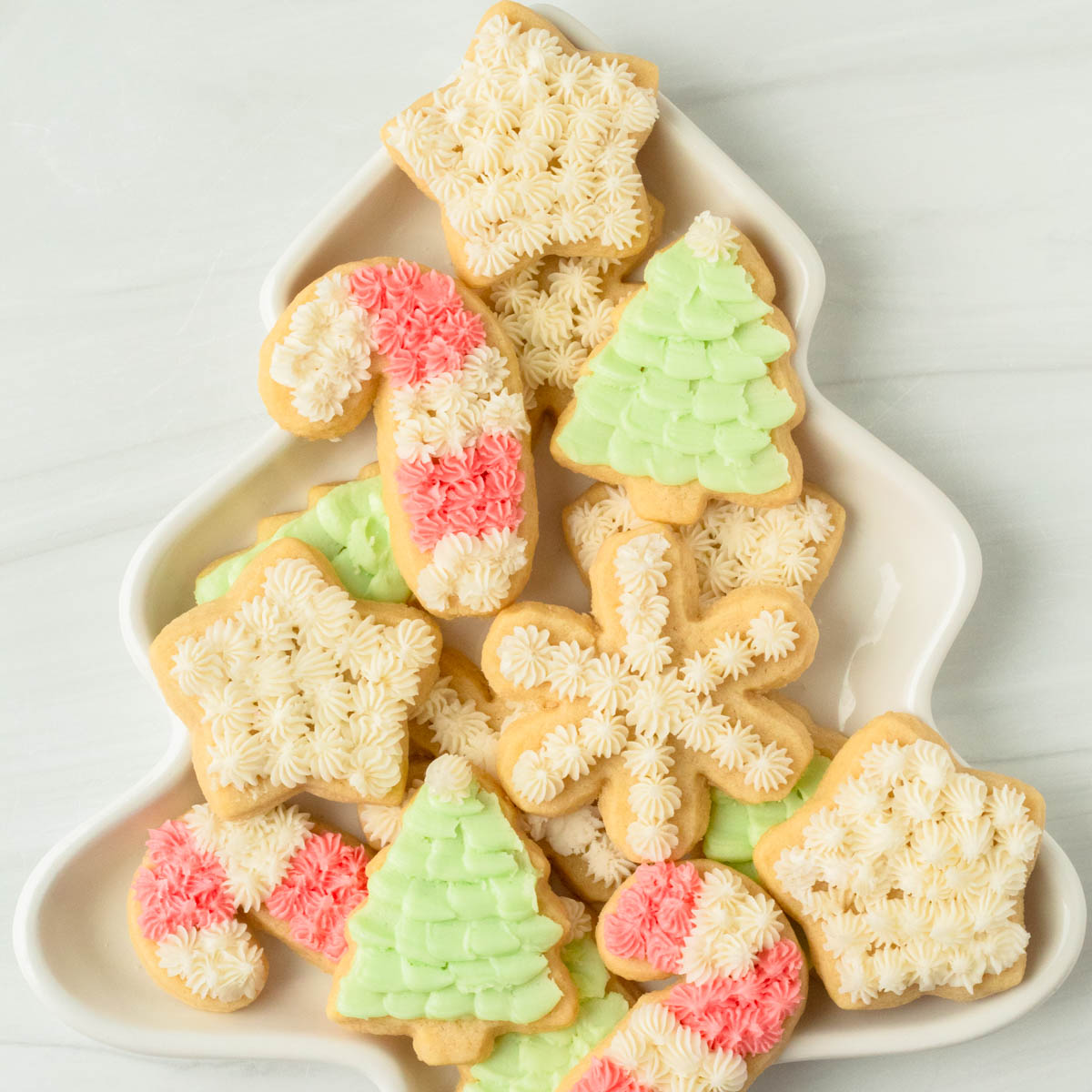 These cut-out sugar cookies are thick and perfectly soft sugar cookies decorated with homemade buttercream frosting and perfect for any holiday including Christmas, Easter, birthdays, baby showers and more!
