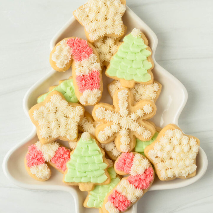 These cut-out sugar cookies are thick and perfectly soft sugar cookies decorated with homemade buttercream frosting and perfect for any holiday including Christmas, Easter, birthdays, baby showers and more!