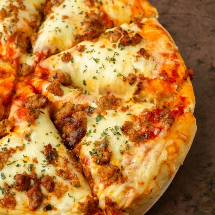 This homemade pizza is an easy to make thick crust pizza recipe made with pantry staple ingredients and easily customized with your favorite toppings for a delicious pizza you can make at home.