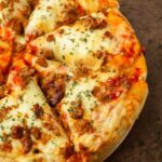 This homemade pizza is an easy to make thick crust pizza recipe made with pantry staple ingredients and easily customized with your favorite toppings for a delicious pizza you can make at home.