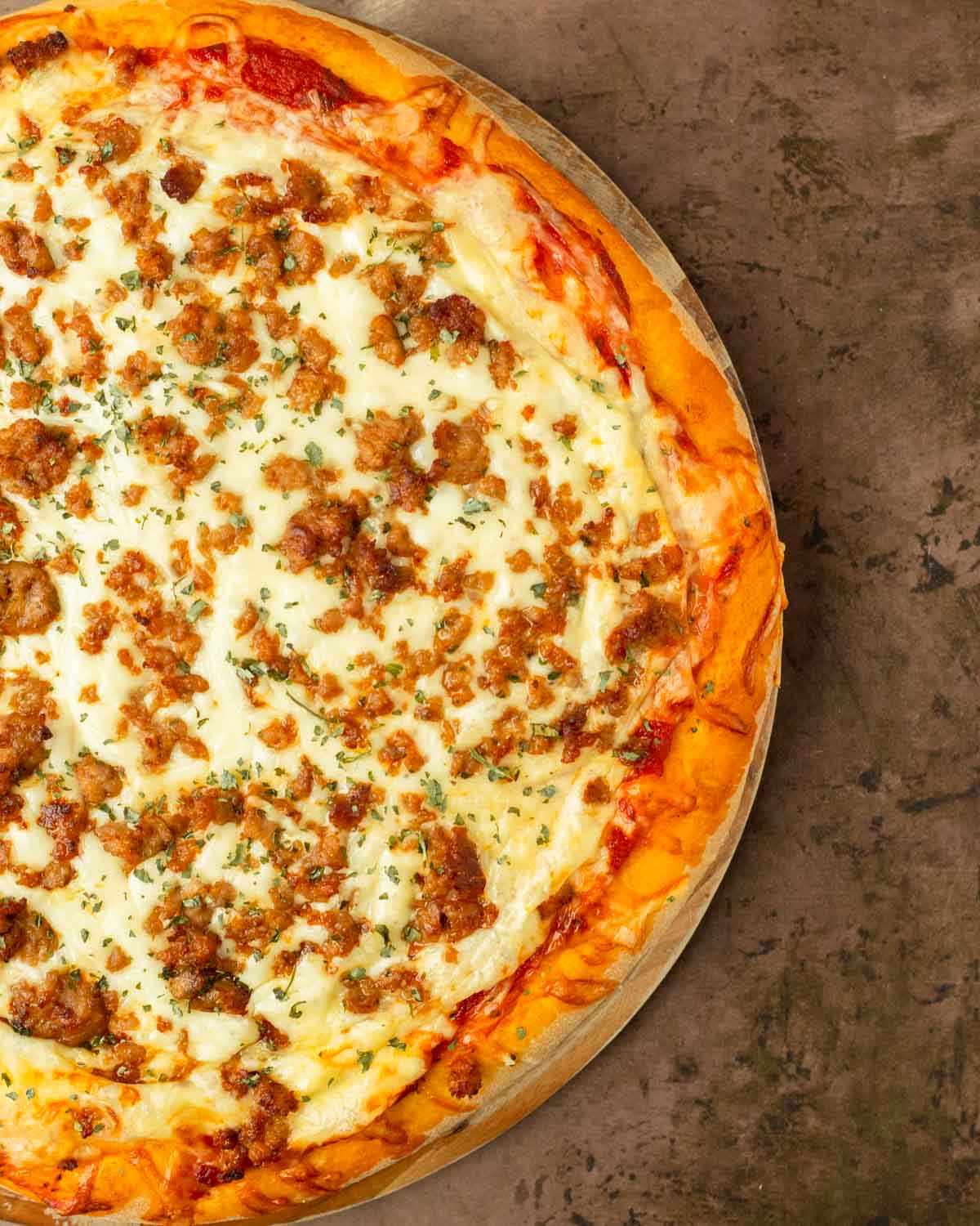 This homemade pizza is an easy to make thick crust pizza recipe made with pantry staple ingredients and easily customized with your favorite toppings for a delicious pizza you can make at home.