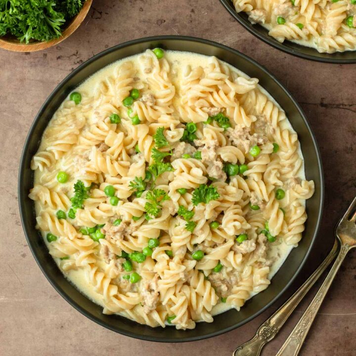 This pork sausage and pea alfredo is a delicious and easy weeknight dinner recipe made with pork sausage and peas cooked in a creamy alfredo sauce and mixed with noodles for a delicious and filling comfort food meal.