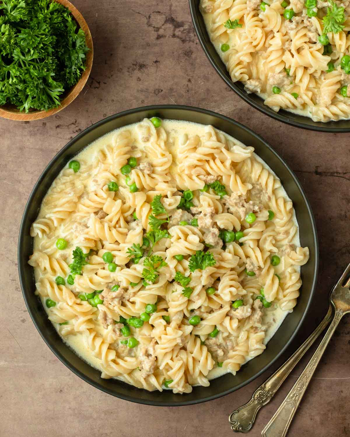 This pork sausage and pea alfredo is a delicious and easy weeknight dinner recipe made with pork sausage and peas cooked in a creamy alfredo sauce and mixed with noodles for a delicious and filling comfort food meal.