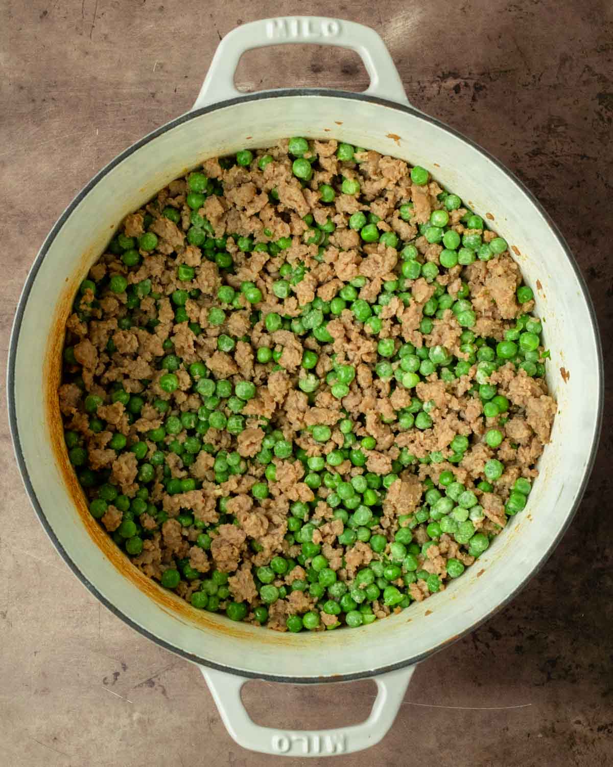 Step 1. Brown the sausage and stir in the spices, butter and peas