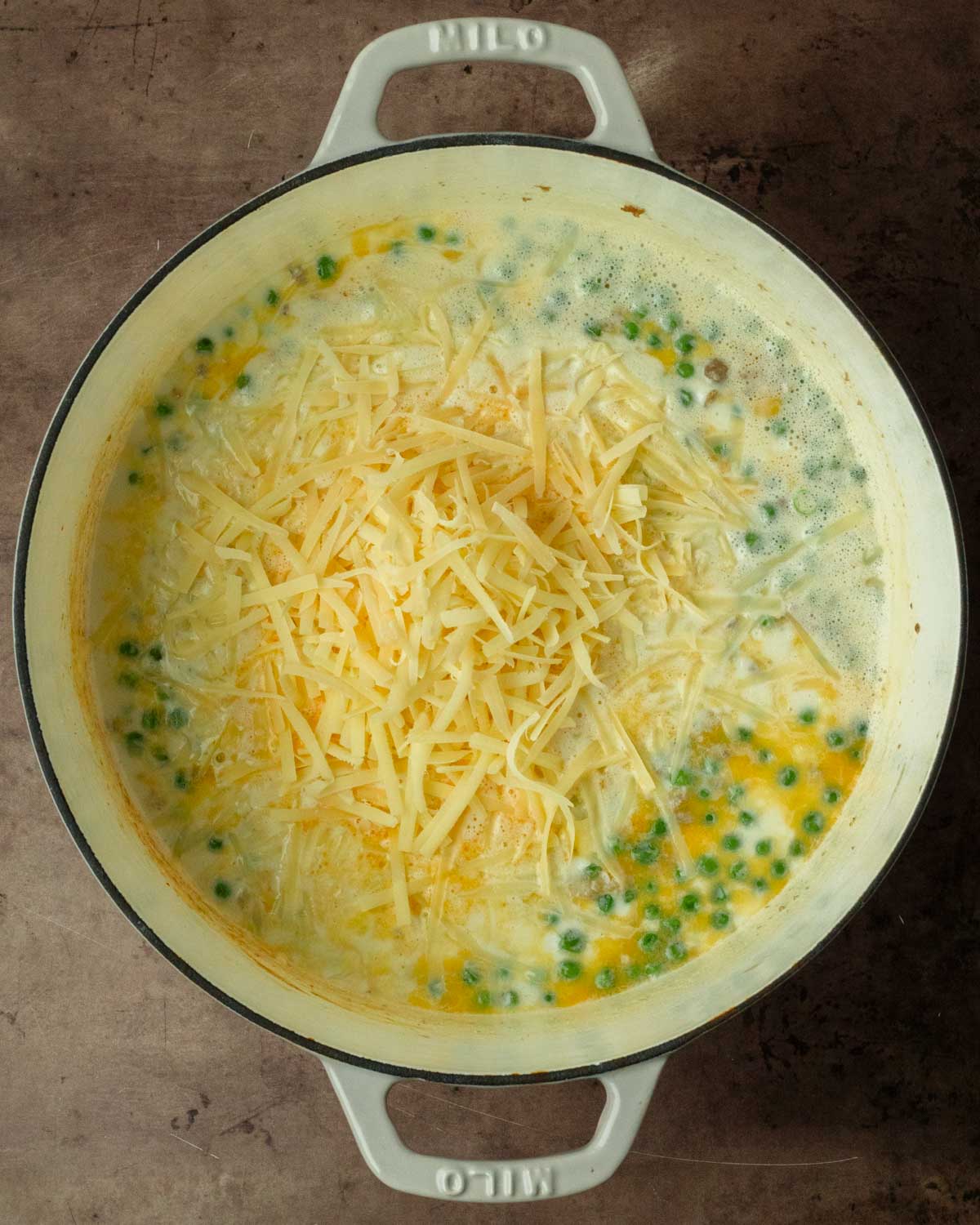 Step 2. Pour in the liquids, bring to a boil, then mix in the cheese