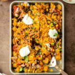 These bbq pulld pork totchos are made with crispy tater tots loaded with cheese, bbq pulled pork and other delicious toppings for a flavorful and crowd-pleaser dinner the entire family will love.