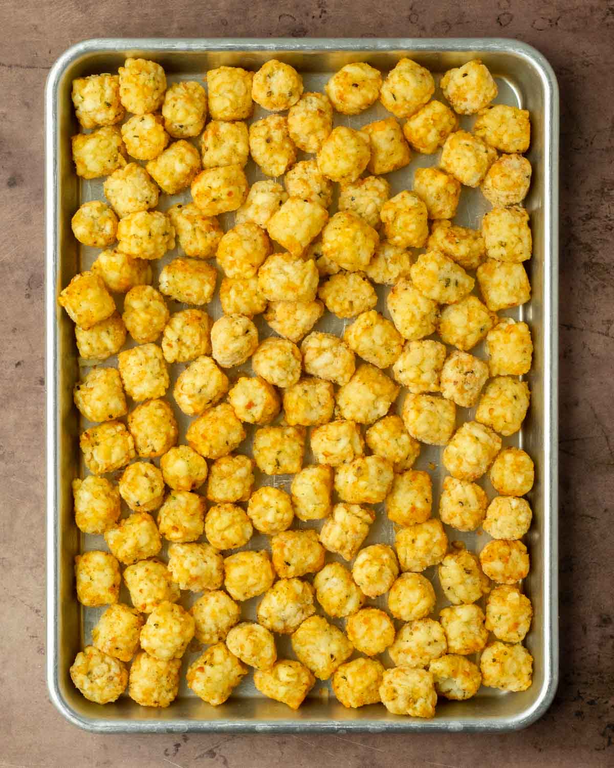Step 1. Spread the tater tots out on the sheet pan and cook in the oven