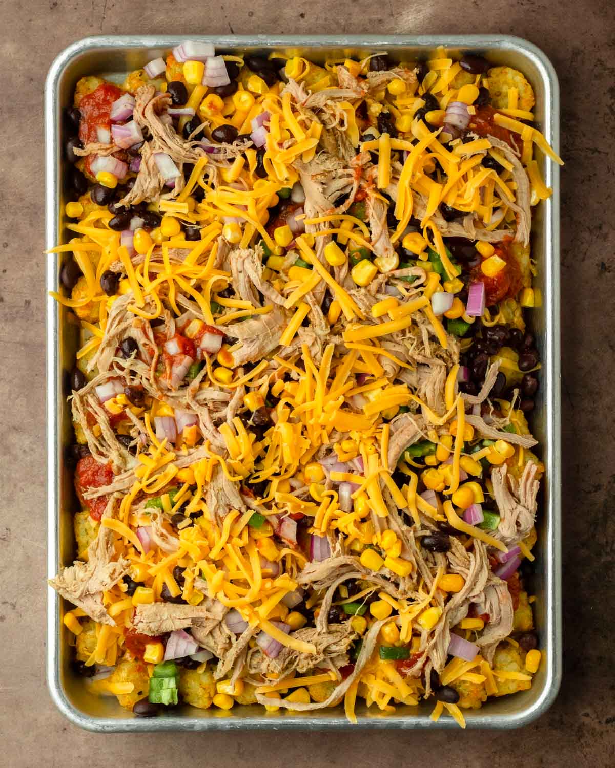 Step 2. Add the toppings on top of the tater tots