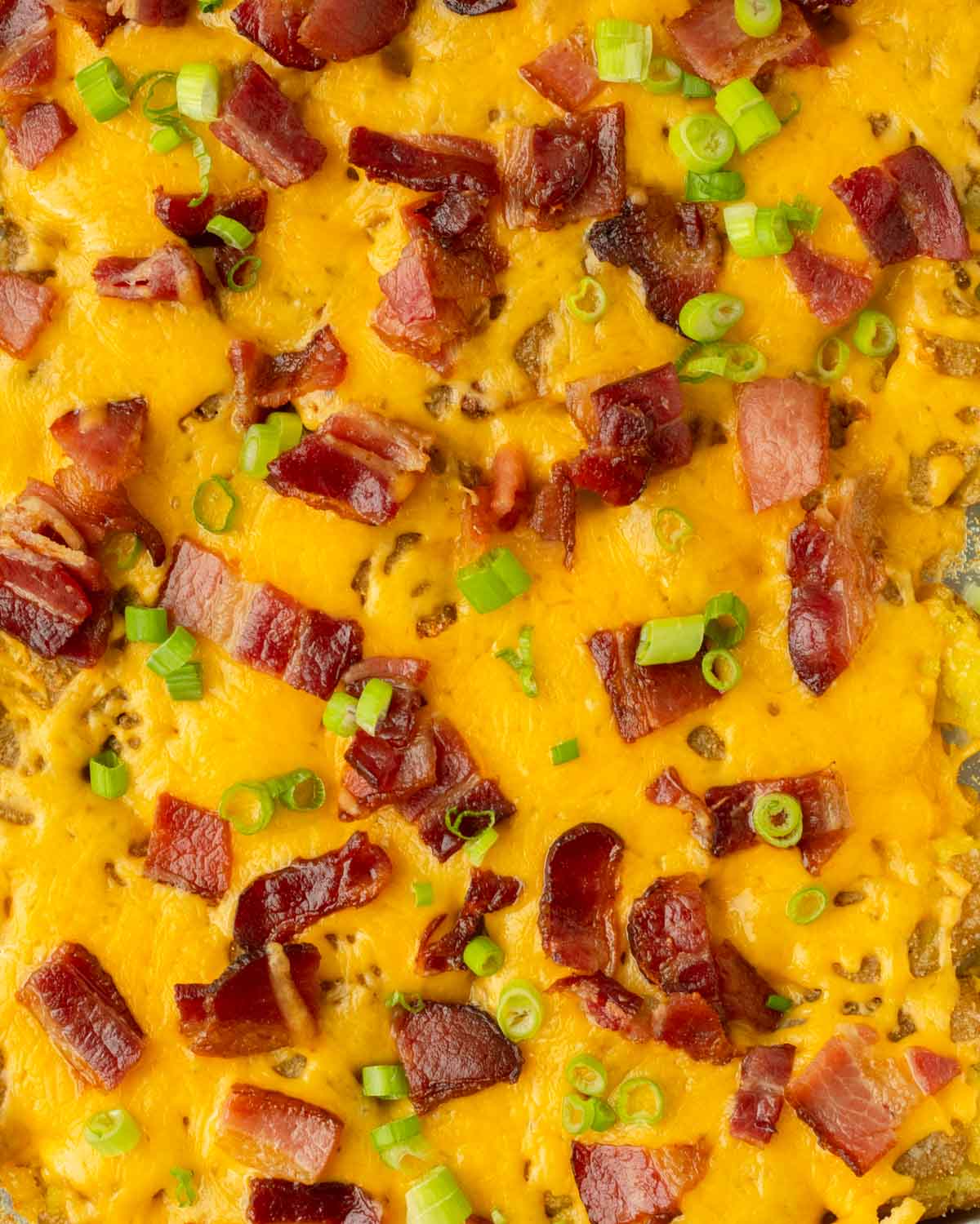 These twice baked smashed potatoes are everyone's favorite classic summer side dish made with crispy smashed potatoes baked on a sheet pan and topped with cheddar cheese and bacon. This recipe is perfect for a weeknight dinner side but also great to serve to a crowd.