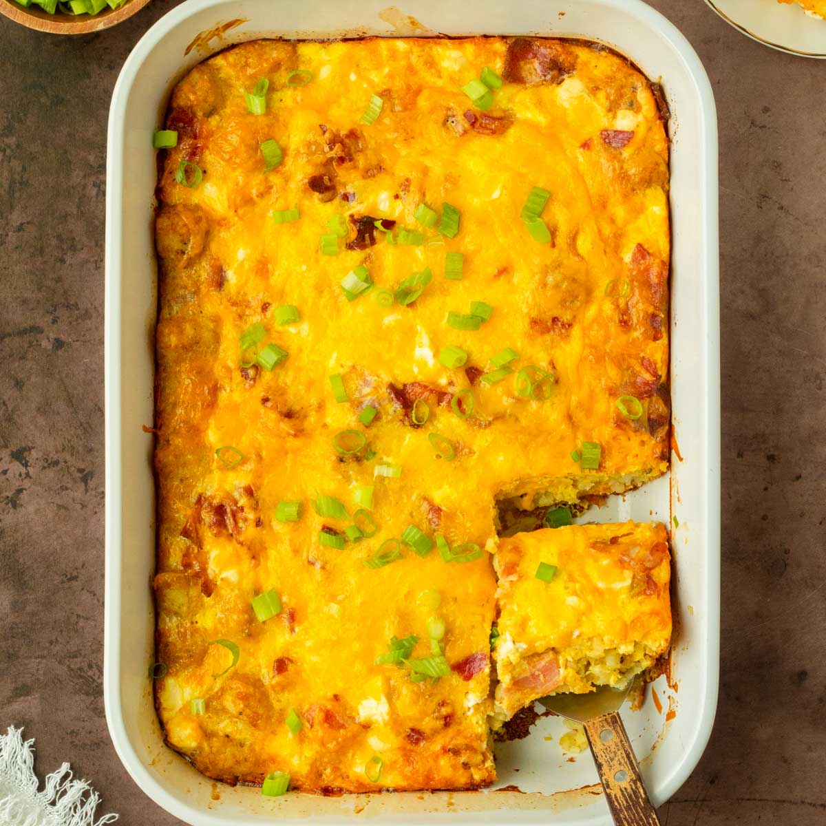 This bacon tater tot breakfast casserole is a flavorful and filling homemade breakfast casserole made with a delicious cheesy bacon-filled egg mixture baked over a layer of tater tots perfect for a weekend brunch and to serve for a crowd.