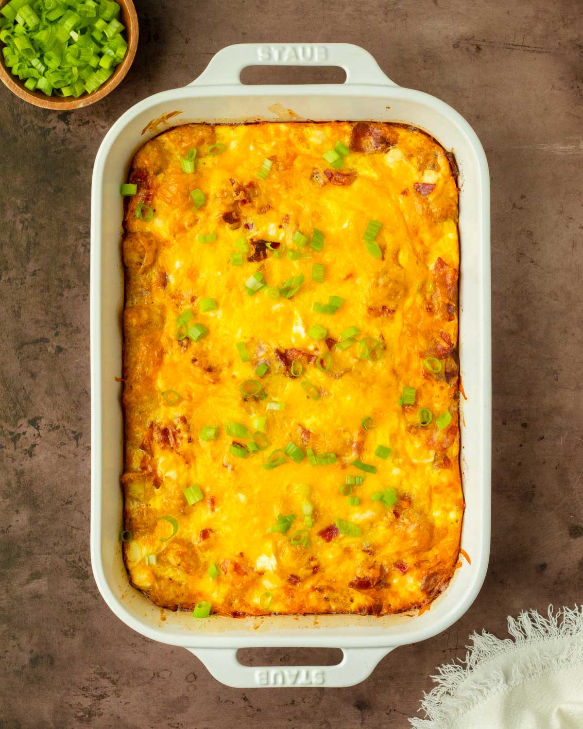This bacon tater tot breakfast casserole is a flavorful and filling homemade breakfast casserole made with a delicious cheesy bacon-filled egg mixture baked over a layer of tater tots perfect for a weekend brunch and to serve for a crowd.