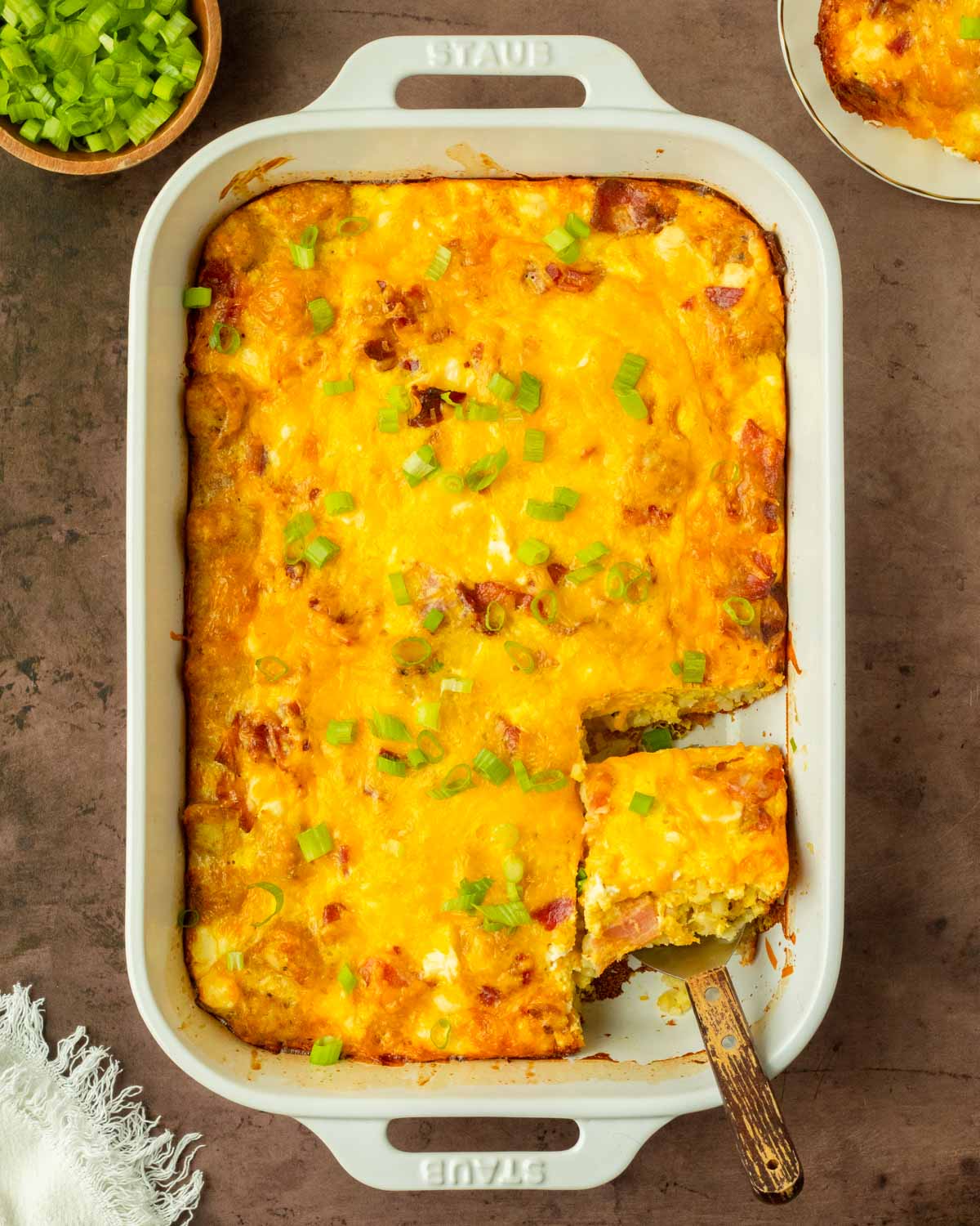 This bacon tater tot breakfast casserole is a flavorful and filling homemade breakfast casserole made with a delicious cheesy bacon-filled egg mixture baked over a layer of tater tots perfect for a weekend brunch and to serve for a crowd.