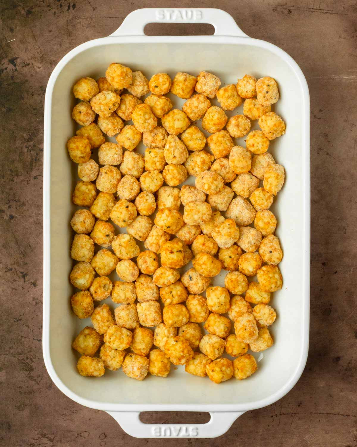 Step 1. Spread the tater tots over the bottom of the baking dish
